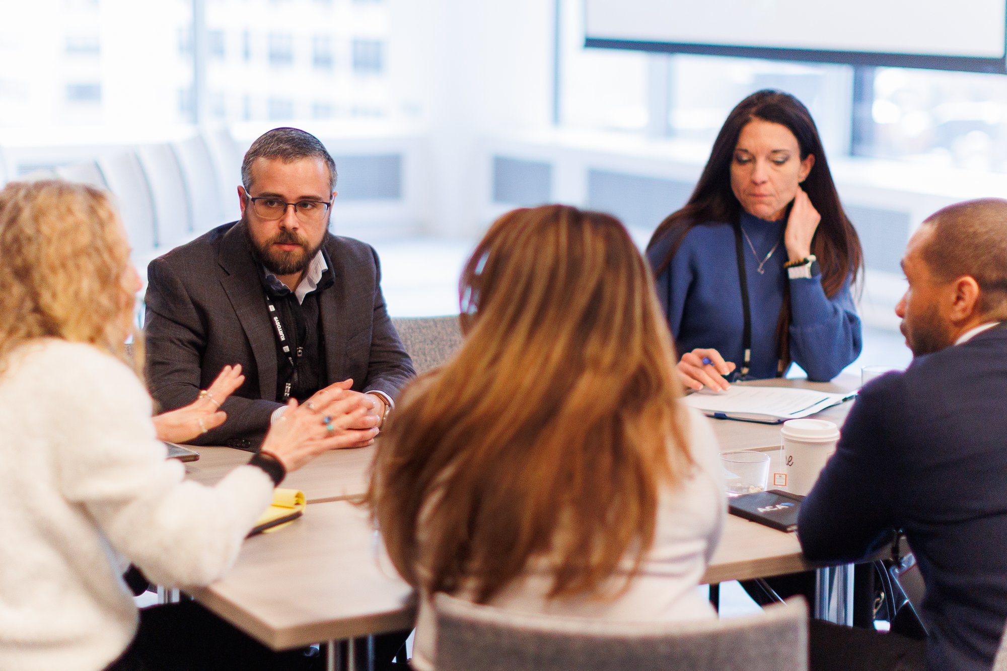 A group of PMCR attendees engaging in conversation during a peer-to-peer workshop at PMCR 2026